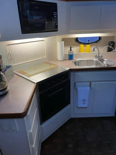 Slide: The Image of 1996 Carver 370 interior dining area with cozy seating and nautical decor. - 28