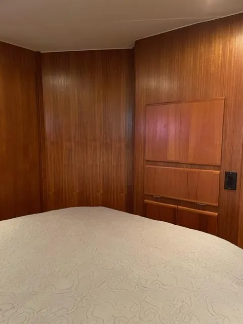 Slide: The Image of 1996 Carver 370 yacht docked, featuring a covered deck and American flag. - 38