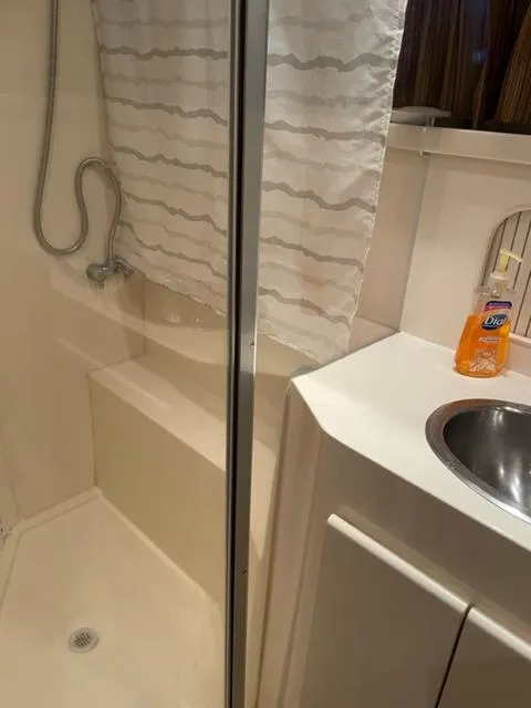 Slide: The Image of Interior view of a 1996 Carver 370 yacht with seating and marina backdrop. - 40