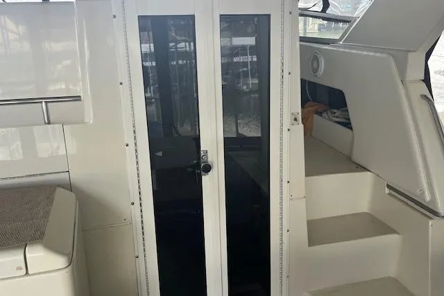 Slide: The Image of Interior view of a 1996 Carver 370 yacht, featuring a glass door and stairs. - 46