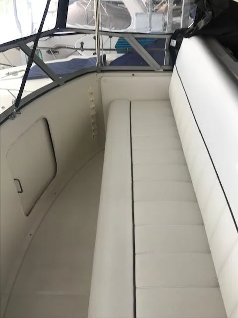 Slide: The Image of 1996 Carver 370 boat interior with white seating. - 11