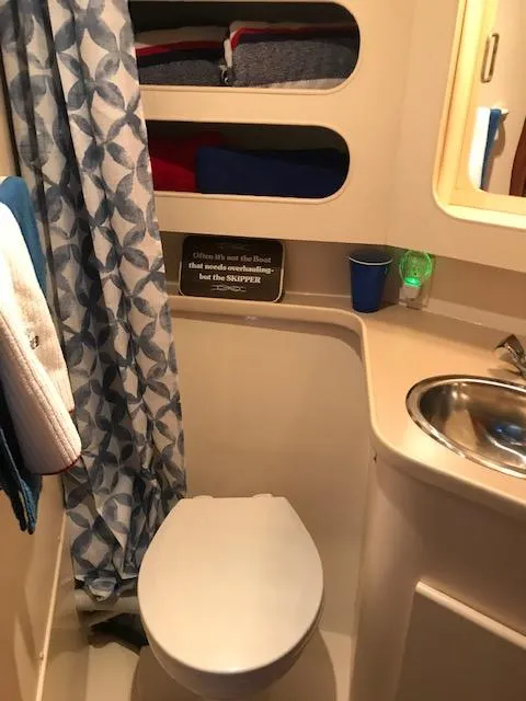 Slide: The Image of Cozy interior of a 1996 Carver 370 yacht with a TV, chair, and window. - 18