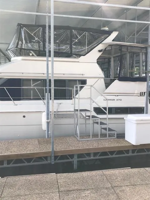 Slide: The Image of 1996 Carver 370 yacht docked in a covered marina. - 2
