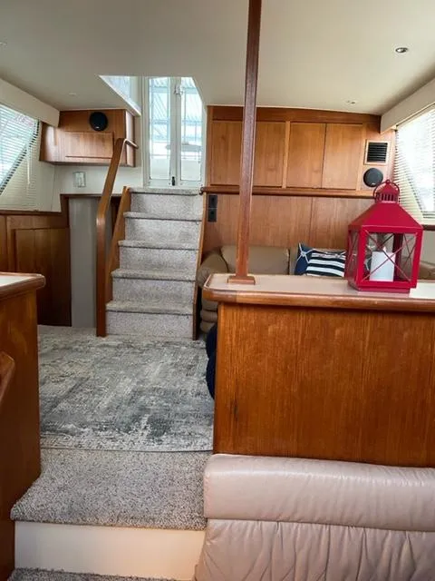 Slide: The Image of Interior of a 1996 Carver 370 yacht with wooden cabinetry and carpeted stairs. - 21