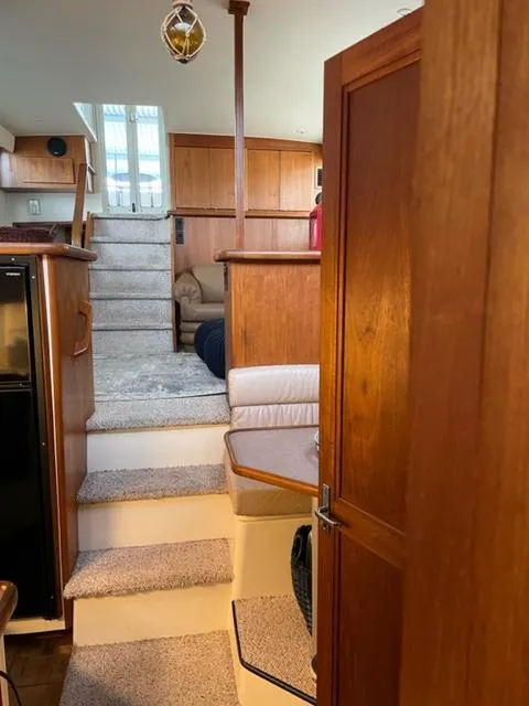 Slide: The Image of 1996 Carver 370 yacht interior with wooden door and cozy bedroom. - 26