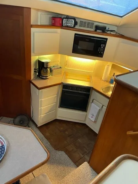 Slide: The Image of Cozy cabin interior of a 1996 Carver 370 yacht with nautical-themed bedding. - 27
