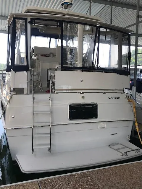 Slide: The Image of 1996 Carver 370 yacht docked in a covered marina. - 3