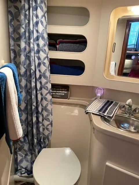 Slide: The Image of 1996 Carver 370 yacht bedroom with cozy bed and nautical decor. - 30
