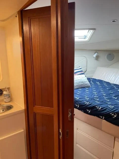 Slide: The Image of Luxurious bedroom interior of a 1996 Carver 370 yacht with cozy bedding and nautical decor. - 31