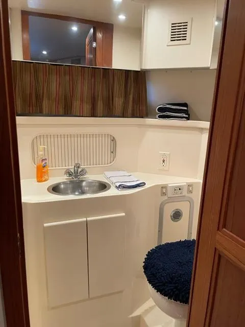 Slide: The Image of 1996 Carver 370 yacht interior with seating and windows overlooking marina. - 39