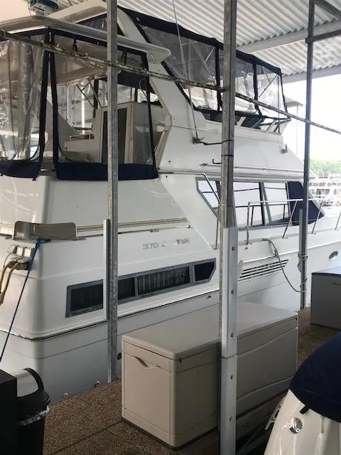 Slide: The Image of 1996 Carver 370 yacht docked in a covered marina. - 4