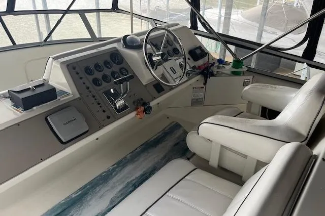 Slide: The Image of Interior cockpit of 1996 Carver 370 yacht with steering wheel and control panel. - 44