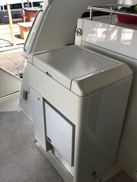 Slide: The Image of Interior of a 1996 Carver 370 yacht with chairs and a small table. - 7