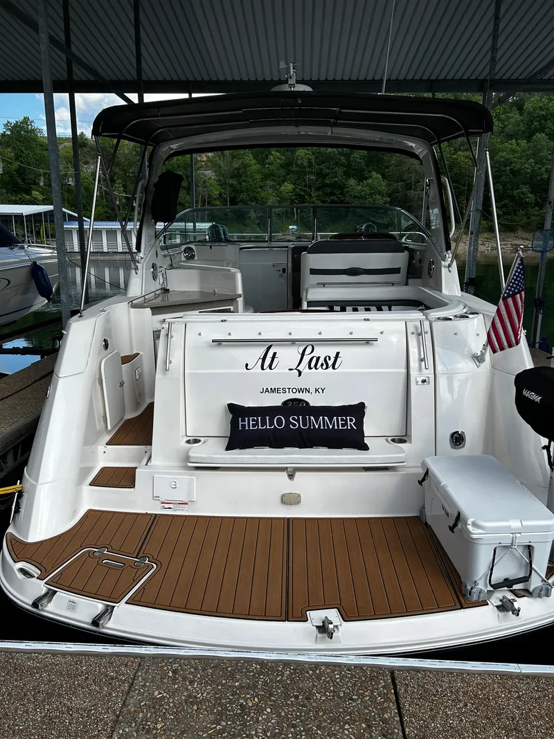 Slide: The Image of 2008 Rinker 350 Express Cruiser docked, featuring At Last name and Hello Summer pillow. - 18