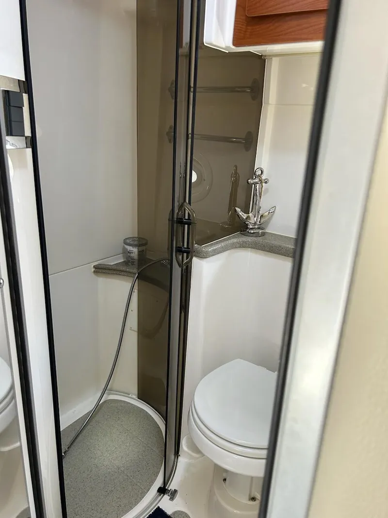 Slide: The Image of 2008 Rinker 350 Express Cruiser bathroom with shower and toilet. - 10