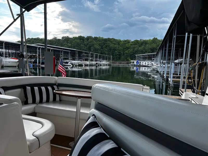 Slide: The Image of 2008 Rinker 350 Express Cruiser docked at a marina with scenic lake view. - 3