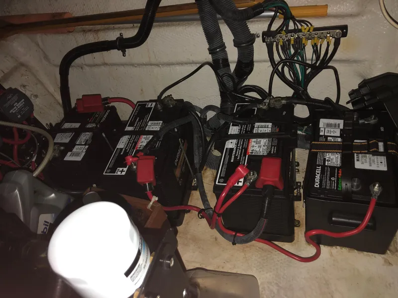 Slide: The Image of Battery compartment of a 2008 Rinker 350 Express Cruiser with multiple batteries and wiring. - 15