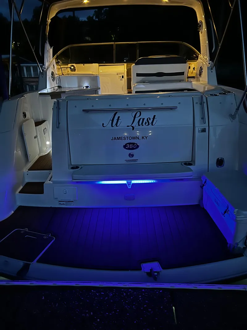 Slide: The Image of 2008 Rinker 350 Express Cruiser with illuminated deck and At Last name. - 19