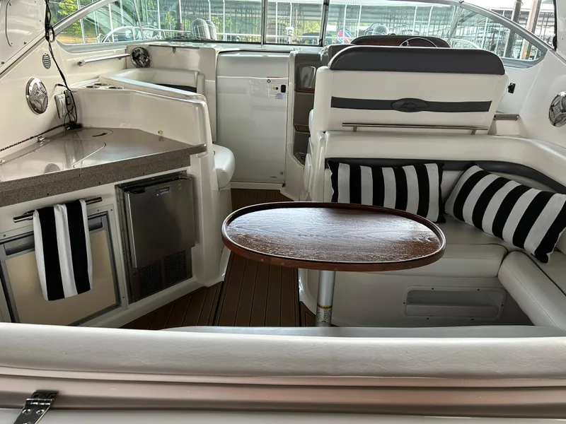 Slide: The Image of 2008 Rinker 350 Express Cruiser interior with kitchenette, seating, and table. - 17