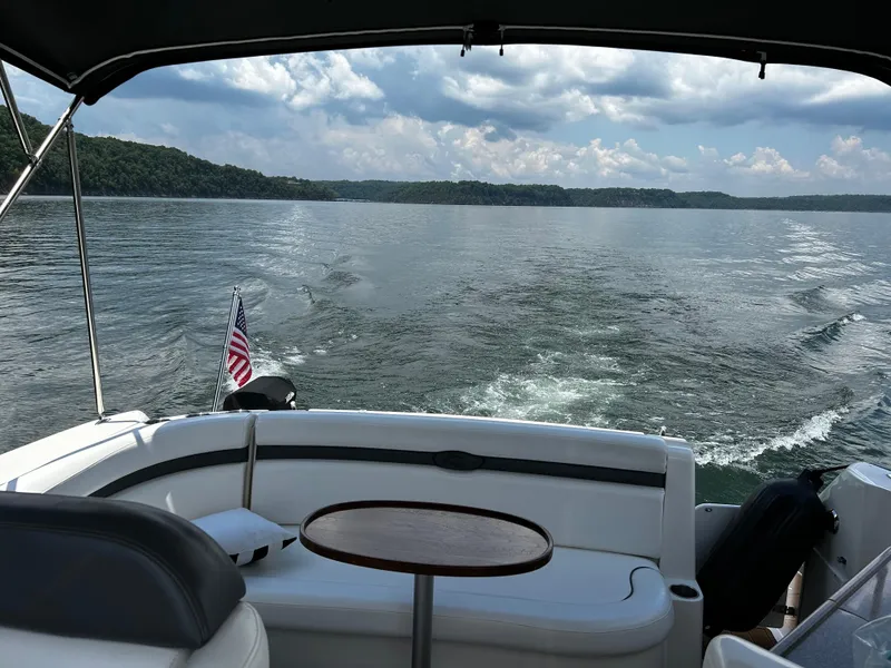 Slide: The Image of 2008 Rinker 350 Express Cruiser on a lake with scenic views. - 2