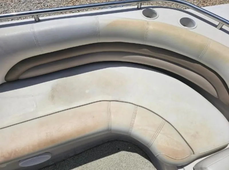 Slide: The Image of 2002 Hurricane Fun Deck GS 232 I/O boat with worn, beige seating. - 17