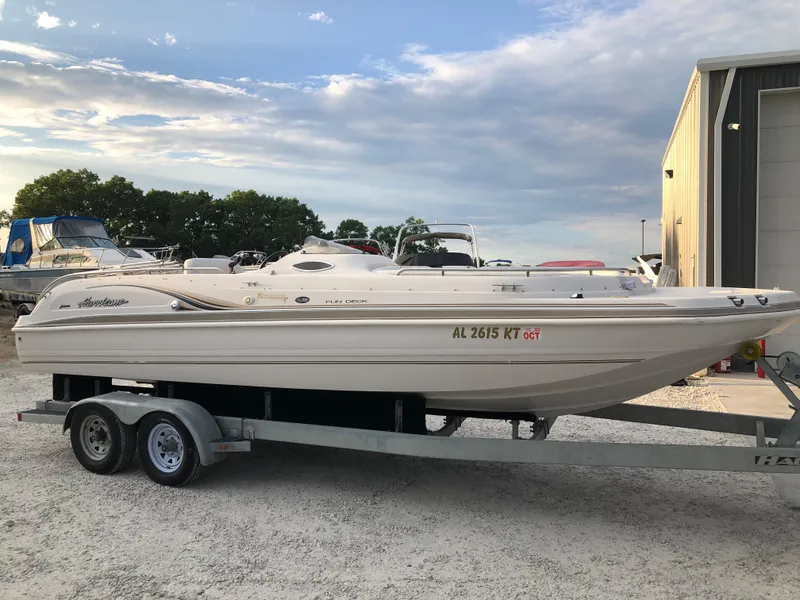 Slide: The Image of 2002 Hurricane Fun Deck GS 232 I/O boat on a trailer at a marina. - 4