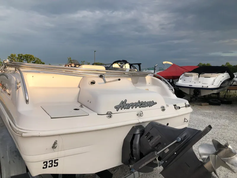 Slide: The Image of 2002 Hurricane Fun Deck GS 232 I/O boat in a storage yard. - 5