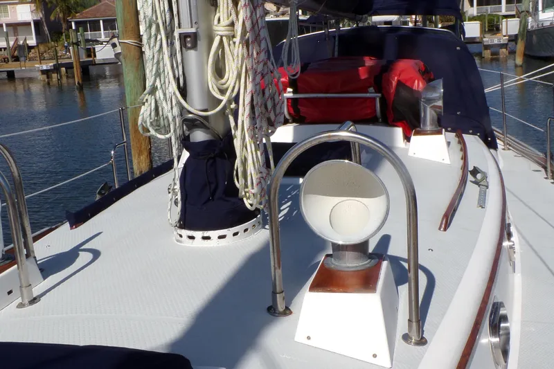 Slide: The Image of Sailboat deck of 1994 Shannon 39 with ropes and equipment in a marina setting. - 4