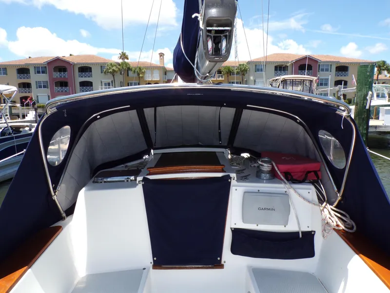 Slide: The Image of Sailboat cockpit view of 1994 Shannon 39, docked with residential buildings in the background. - 6