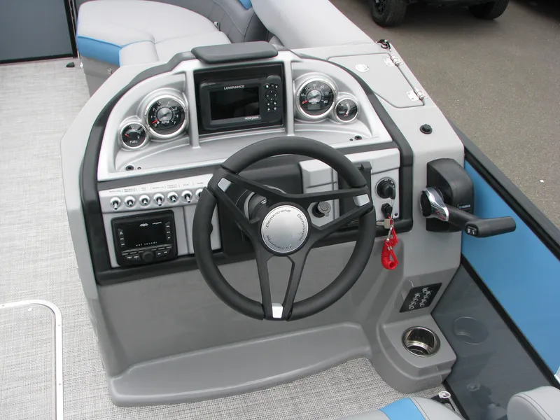 Slide: The Image of 2022 Berkshire 24CL2 CTS boat dashboard with steering wheel and control panel. - 6