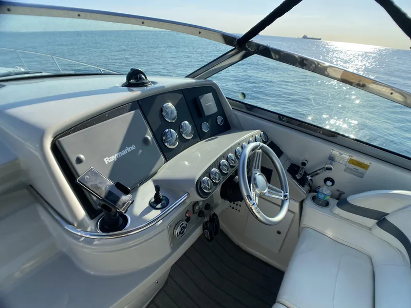 Slide: The Image of 2006 Formula 400 Super Sport boat helm with Raymarine navigation system on open water. - 28