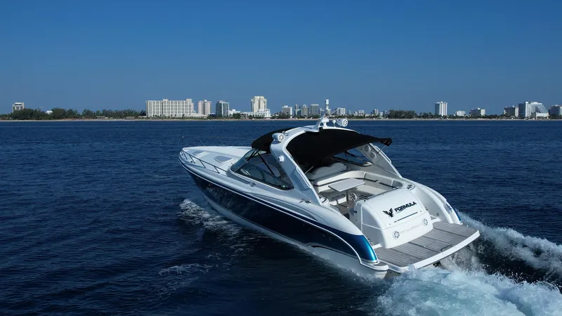 Slide: The Image of 2006 Formula 400 Super Sport yacht cruising on open water near a city skyline. - 3