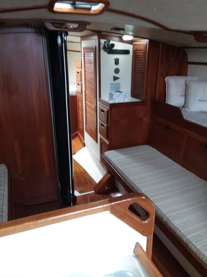 Slide: The Image of Interior of a 1972 Tartan 41 sailboat with wooden furnishings and cozy seating. - 12