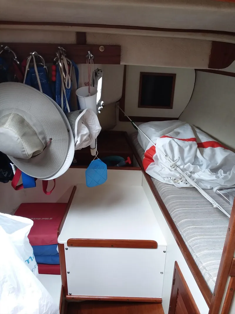 Slide: The Image of Interior of a 1972 Tartan 41 sailboat with bunk, storage, and nautical gear. - 14