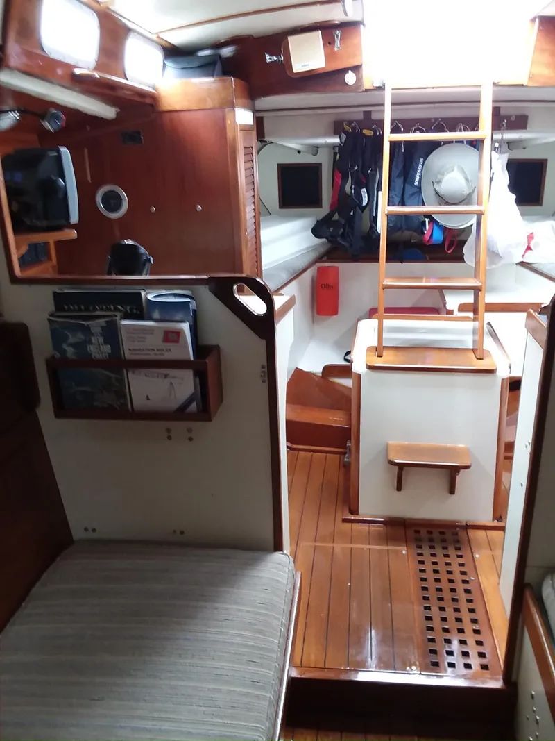 Slide: The Image of Interior of a 1972 Tartan 41 sailboat, featuring wooden finishes and nautical decor. - 16
