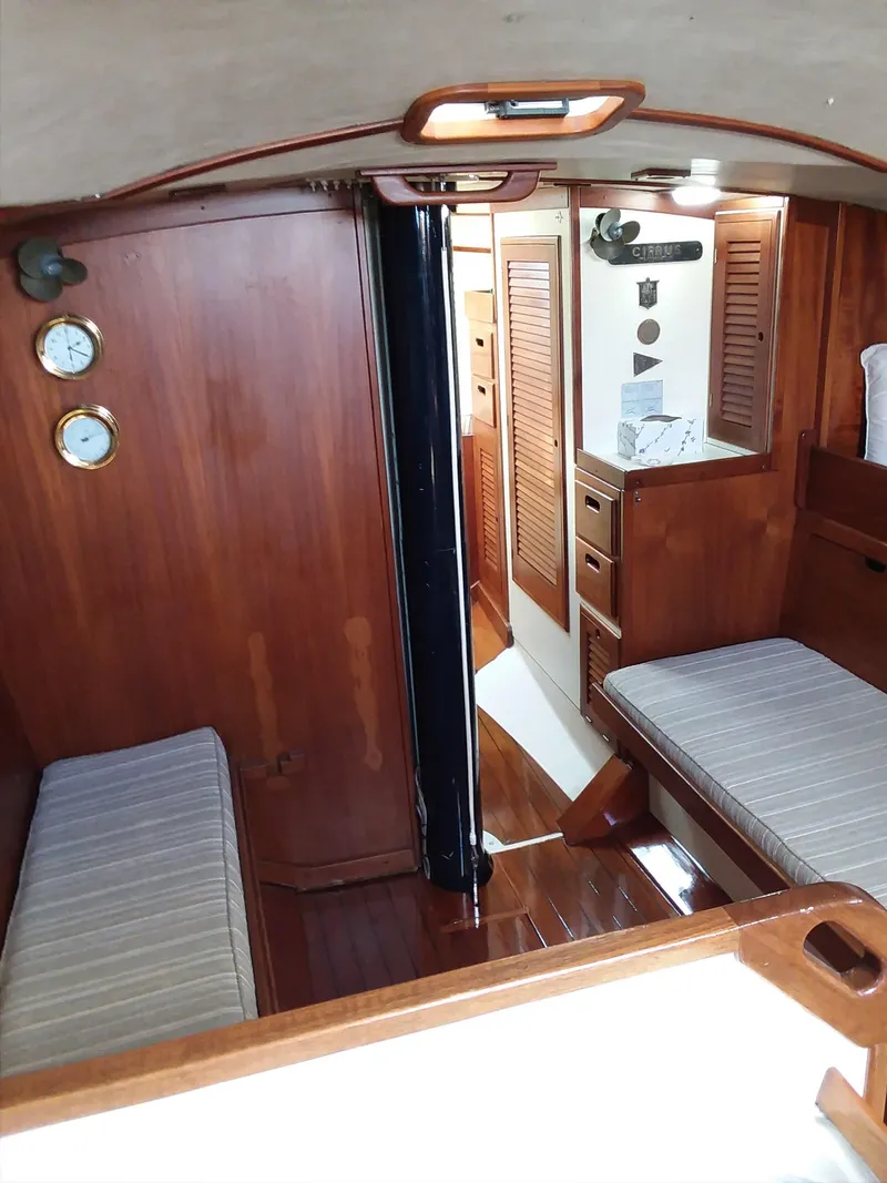 Slide: The Image of 1972 Tartan 41 yacht interior with wooden finish and cozy seating area. - 23