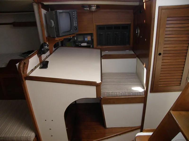 Slide: The Image of 1972 Tartan 41 yacht interior with navigation station and seating area. - 27