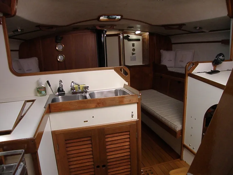 Slide: The Image of Interior of a 1972 Tartan 41 sailboat featuring a compact kitchen and cozy sleeping area. - 28