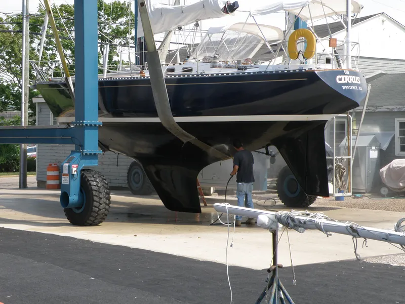 Slide: The Image of 1972 Tartan 41 sailboat in dry dock, undergoing maintenance. - 4