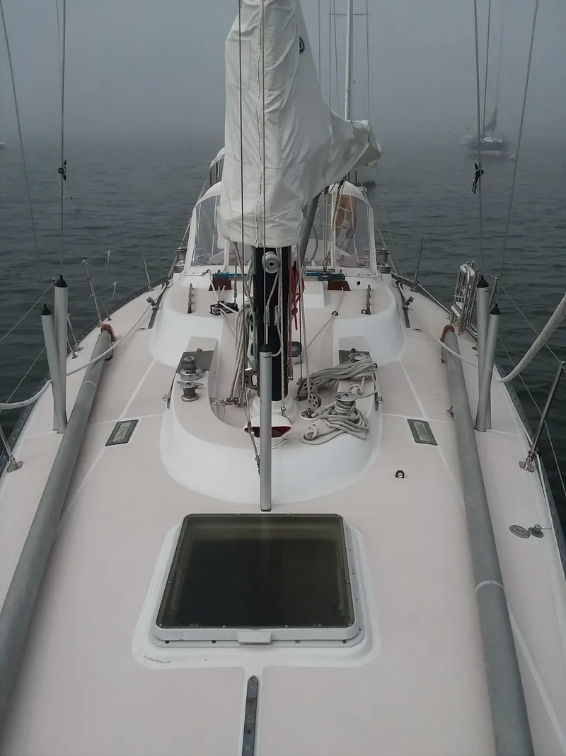 Slide: The Image of 1972 Tartan 41 sailboat deck with mast and rigging in foggy waters. - 5