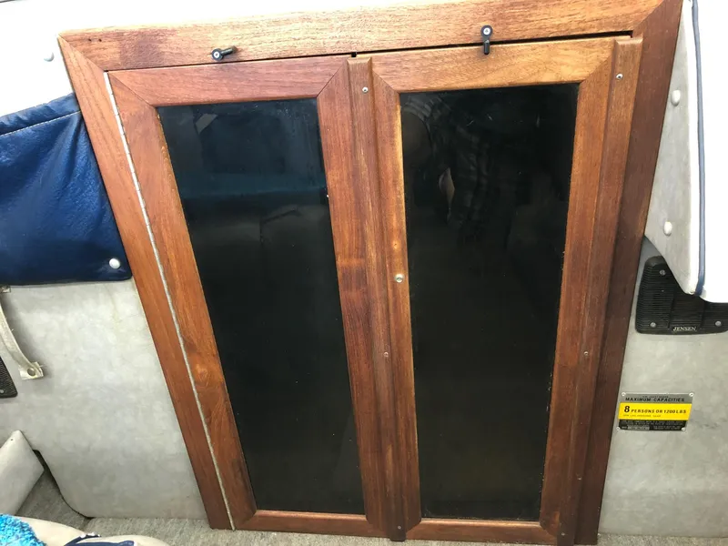 Slide: The Image of Wooden cabinet doors inside 1984 Sea Sprite 18' Cuddy Cabin boat. - 11