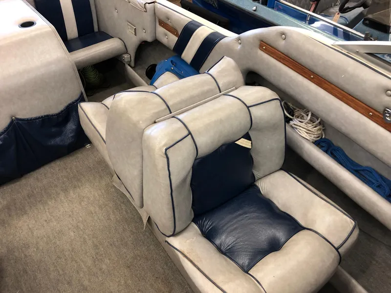 Slide: The Image of 1984 Sea Sprite 18' Cuddy Cabin interior with blue and white seating. - 13