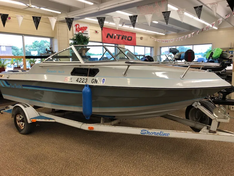 Slide: The Image of 1984 Sea Sprite 18' Cuddy Cabin boat on Shoreline trailer in showroom. - 3