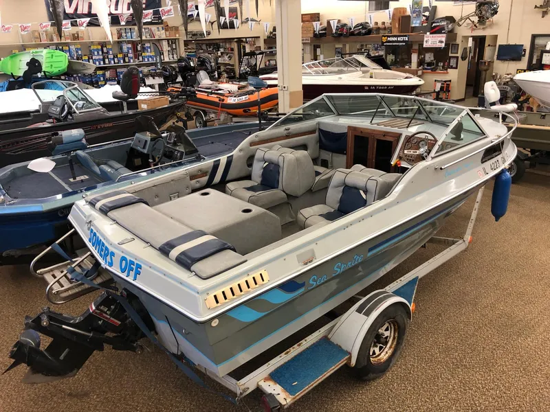 Slide: The Image of 1984 Sea Sprite 18' Cuddy Cabin boat on a trailer in a showroom. - 4