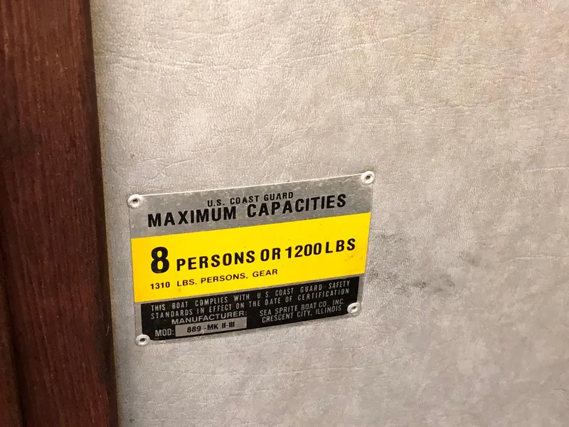 Slide: The Image of 1984 Sea Sprite 18' Cuddy Cabin maximum capacity label, 8 persons or 1200 lbs. - 9