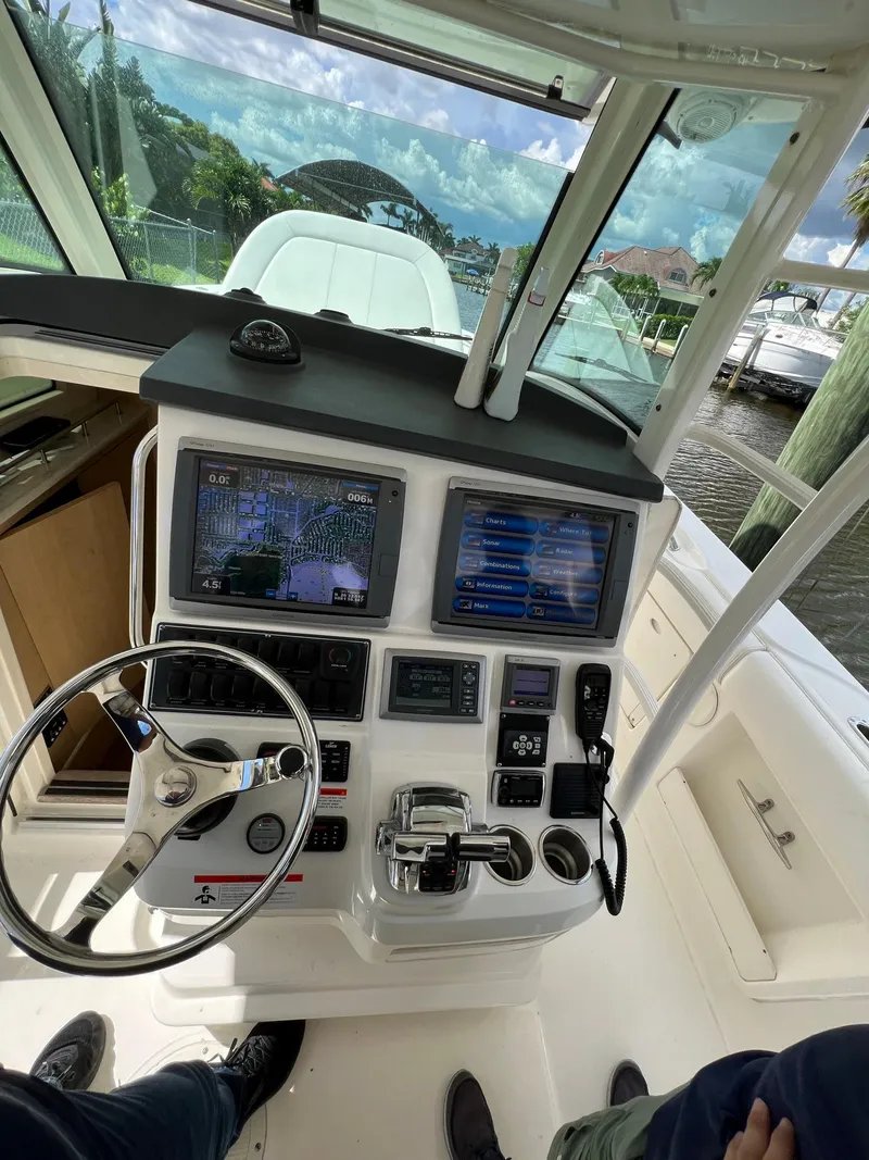Slide: The Image of 2013 Boston Whaler 370 Outrage helm with dual navigation screens. - 11