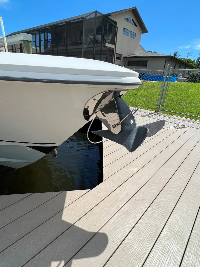 Slide: The Image of 2013 Boston Whaler 370 Outrage boat docked near a residential area. - 14