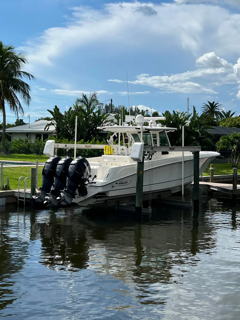 Slide: The Image of 2013 Boston Whaler 370 Outrage docked with triple outboard engines. - 2