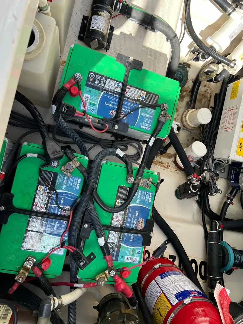 Slide: The Image of 2013 Boston Whaler 370 Outrage engine compartment with batteries and wiring. - 20