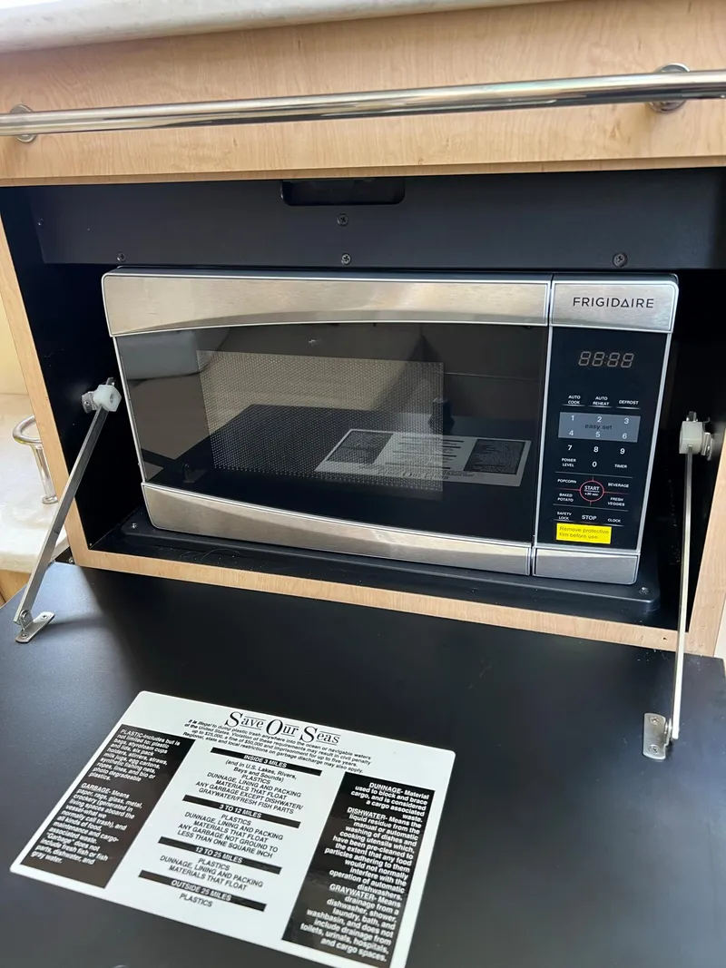 Slide: The Image of Built-in Frigidaire microwave in 2013 Boston Whaler 370 Outrage boat. - 23